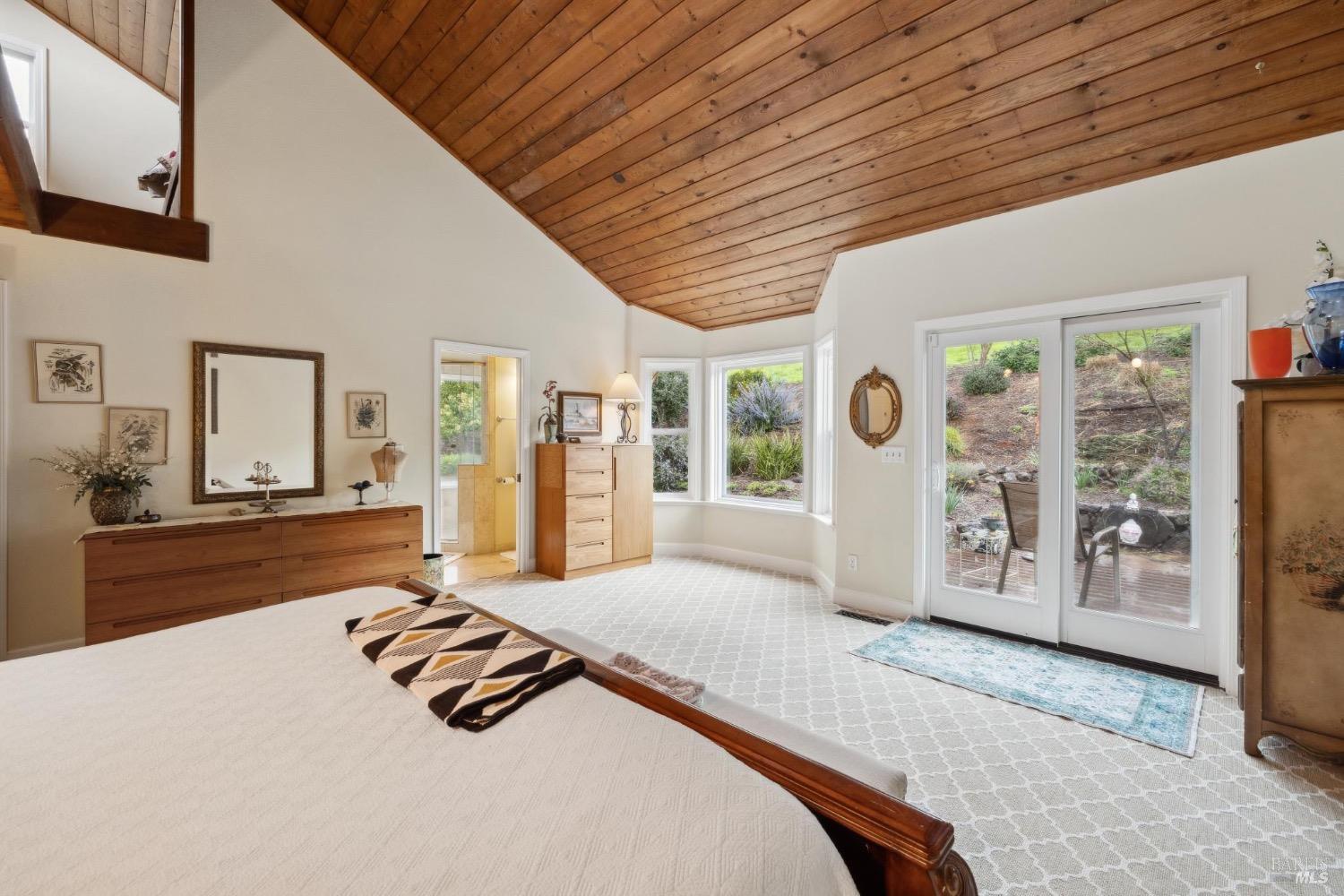 4560 Lovall Valley Loop Road Sonoma, CA 95476 - Photo 37 of 95 a bedroom with furniture and large window