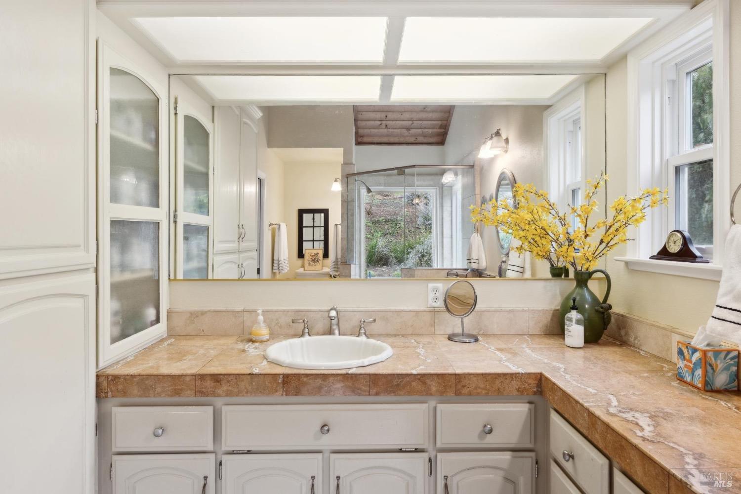 4560 Lovall Valley Loop Road Sonoma, CA 95476 - Photo 41 of 95 a bathroom with a granite countertop sink and a mirror