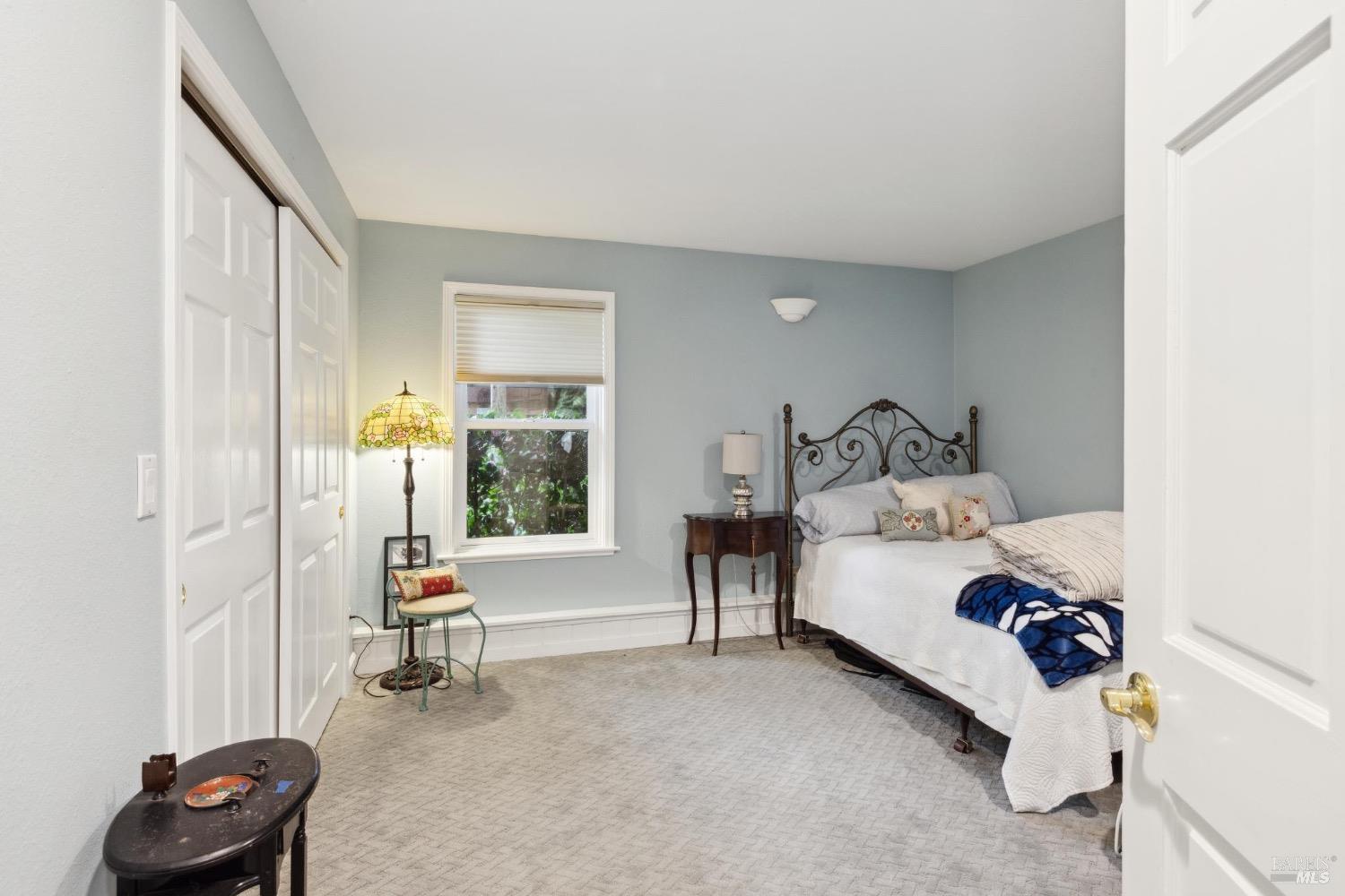 4560 Lovall Valley Loop Road Sonoma, CA 95476 - Photo 47 of 95 a bedroom with a bed and a chair