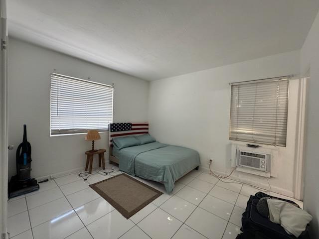 1141 Blue Heron Boulevard, Unit 5 Riviera Beach, FL 33404 - Photo 4 of 8 a bedroom with furniture and a window