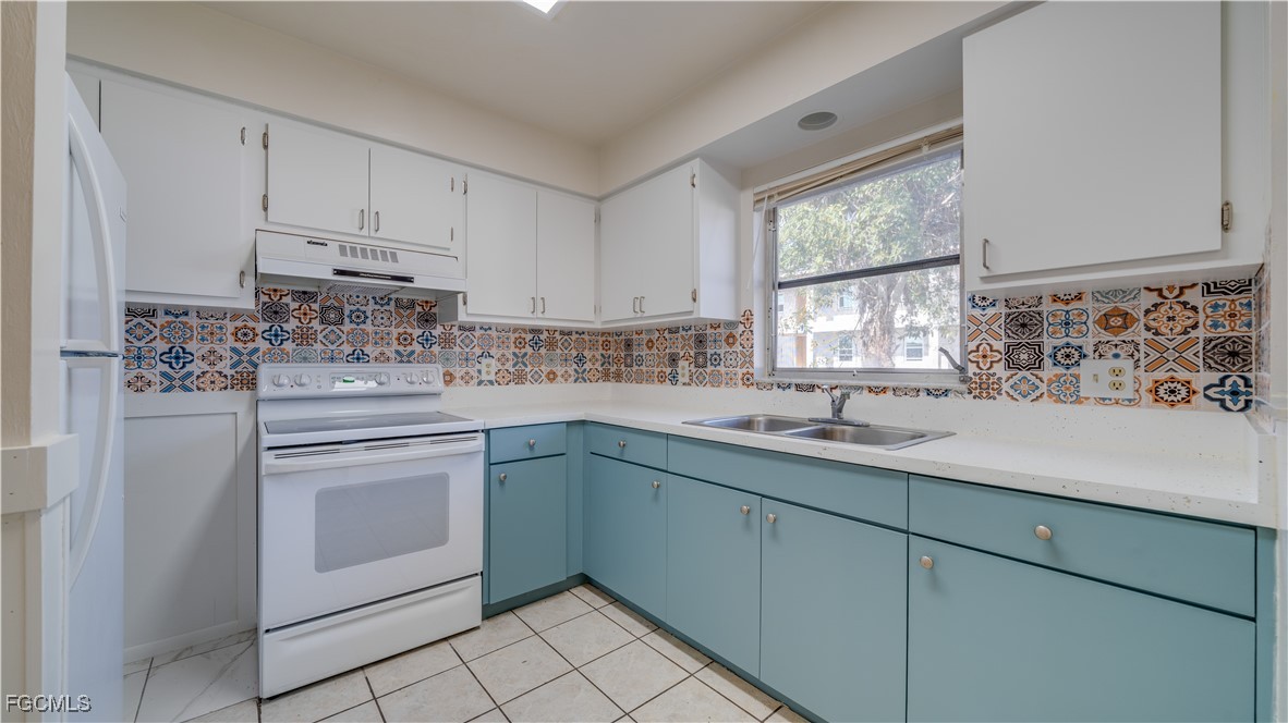 107 Southwest 16th Terrace Cape Coral, FL 33991 - Photo 16 of 31 a kitchen with a sink stove and cabinets