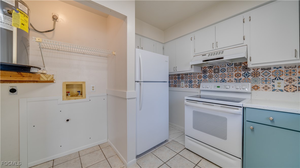 107 Southwest 16th Terrace Cape Coral, FL 33991 - Photo 18 of 31 a kitchen with appliances cabinets and a counter top space