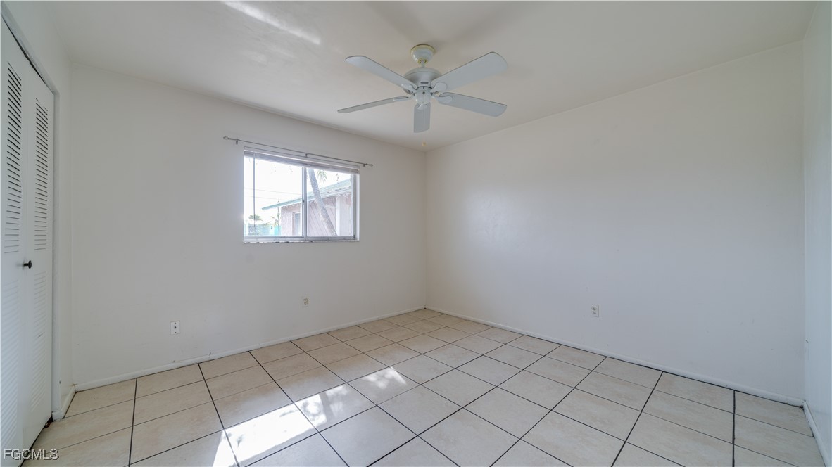 107 Southwest 16th Terrace Cape Coral, FL 33991 - Photo 19 of 31 an empty room with windows and fan