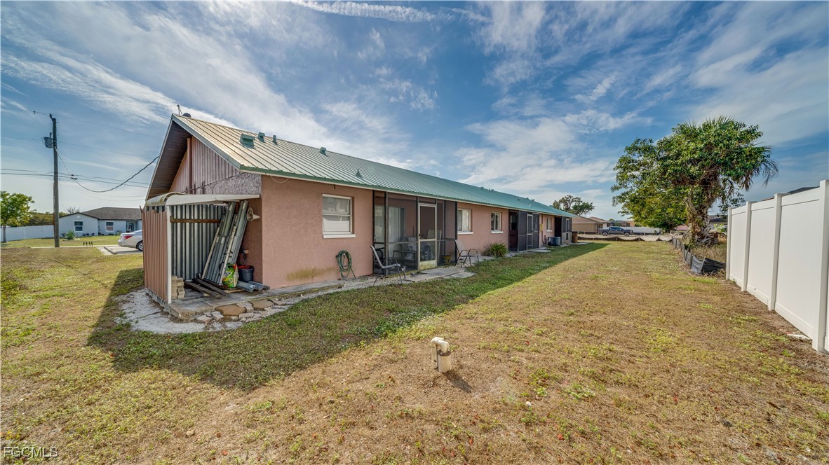 107 Southwest 16th Terrace Cape Coral, FL 33991 - Photo 27 of 31 a view of a house with backyard and sitting area