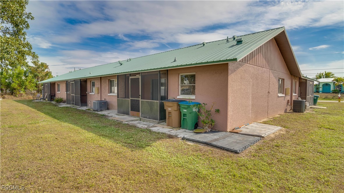 107 Southwest 16th Terrace Cape Coral, FL 33991 - Photo 28 of 31 a view of a house with wooden floor and a yard