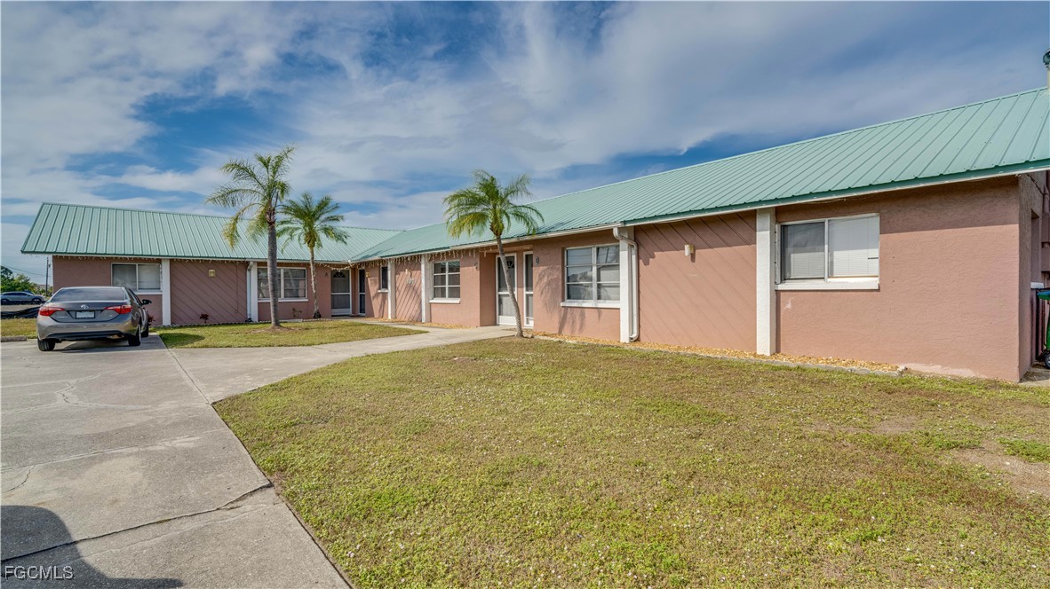 107 Southwest 16th Terrace Cape Coral, FL 33991 - Photo 3 of 31 a view of a house with a garden and parking space