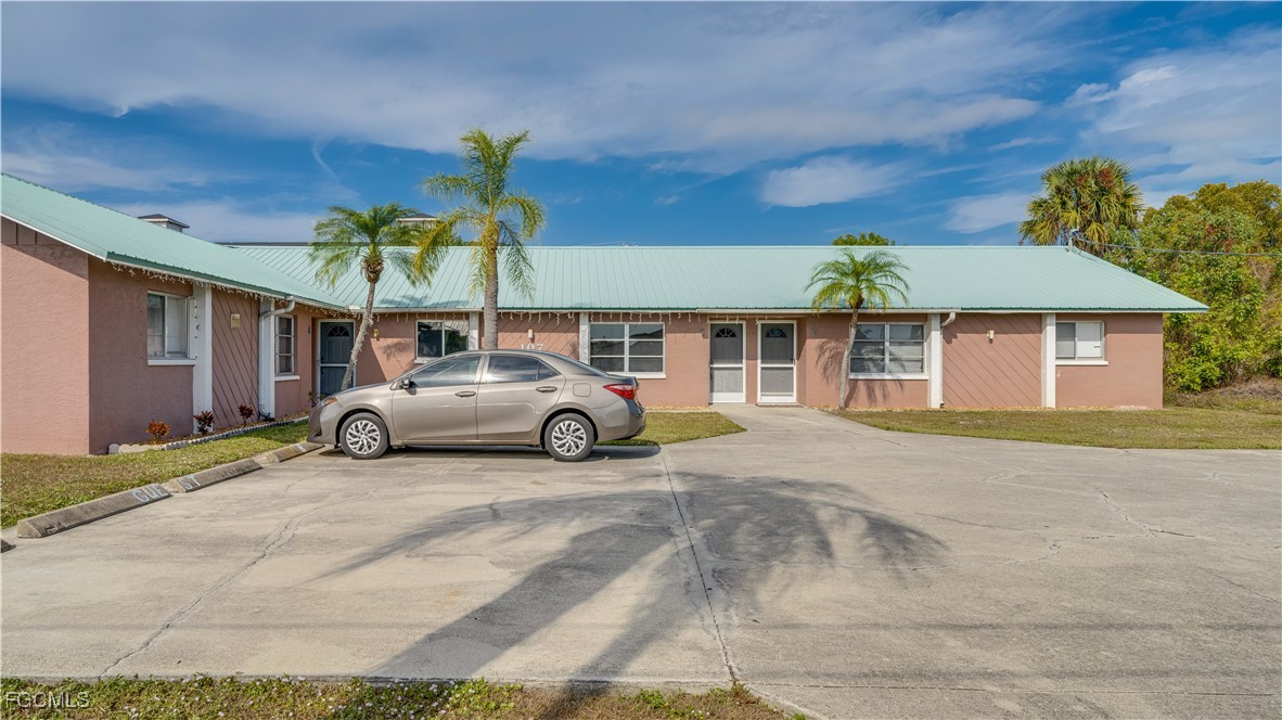 107 Southwest 16th Terrace Cape Coral, FL 33991 - Photo 4 of 31 a car parked in front of a house