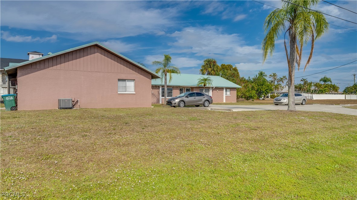 107 Southwest 16th Terrace Cape Coral, FL 33991 - Photo 5 of 31 a view of a house with a yard and potted plants