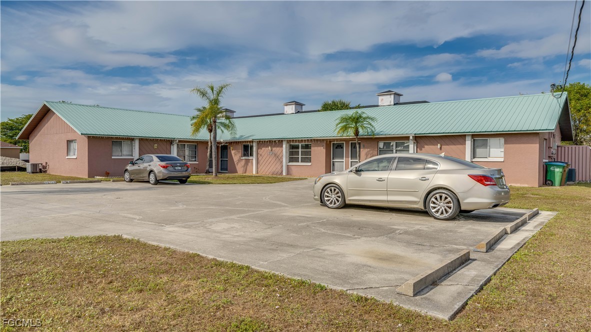 107 Southwest 16th Terrace Cape Coral, FL 33991 - Photo 6 of 31 a car parked in front of a building