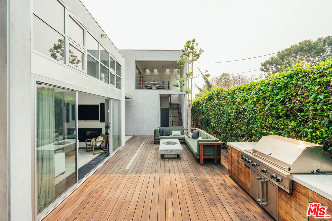 2005 Glencoe Avenue Venice, CA 90291 - Photo 13 of 34 a balcony with wooden floor table and chairs