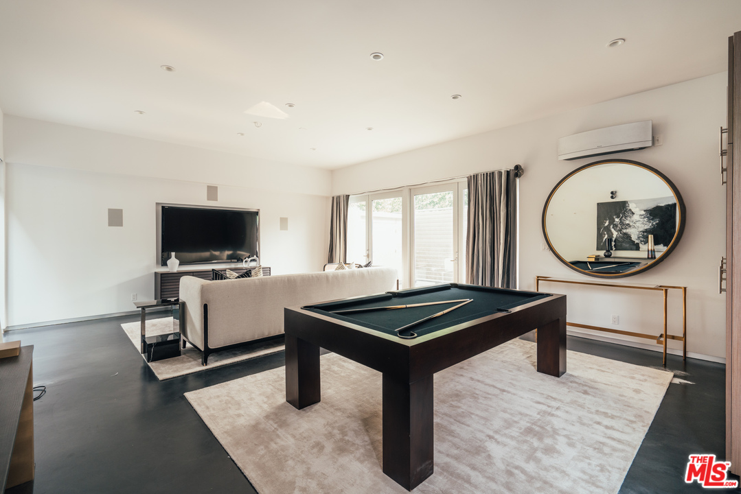 2005 Glencoe Avenue Venice, CA 90291 - Photo 27 of 34 a living room with furniture a flat screen tv and a table