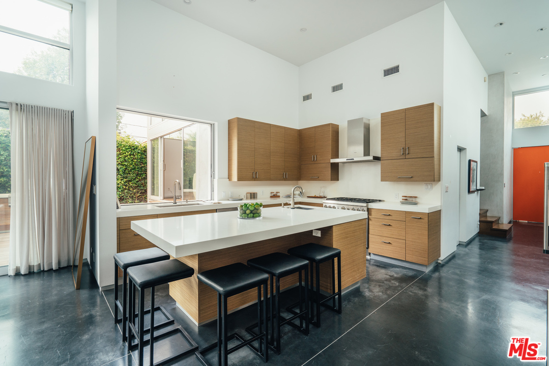 2005 Glencoe Avenue Venice, CA 90291 - Photo 5 of 34 a kitchen with a table chairs sink and cabinets