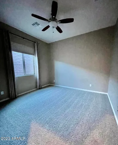 an empty room with a empty space and a ceiling fan