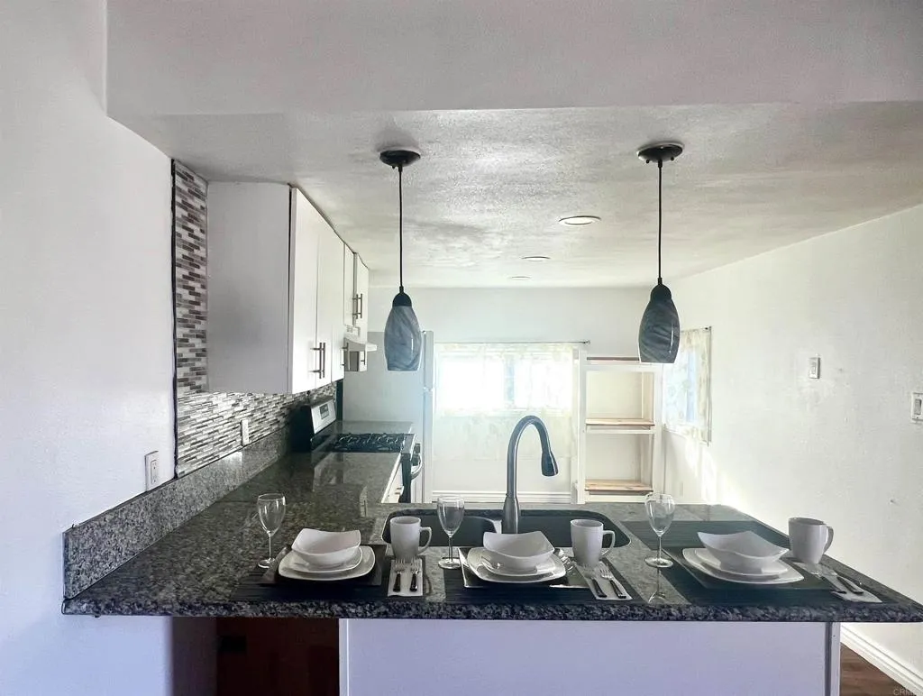 a table with chairs and a wooden floor