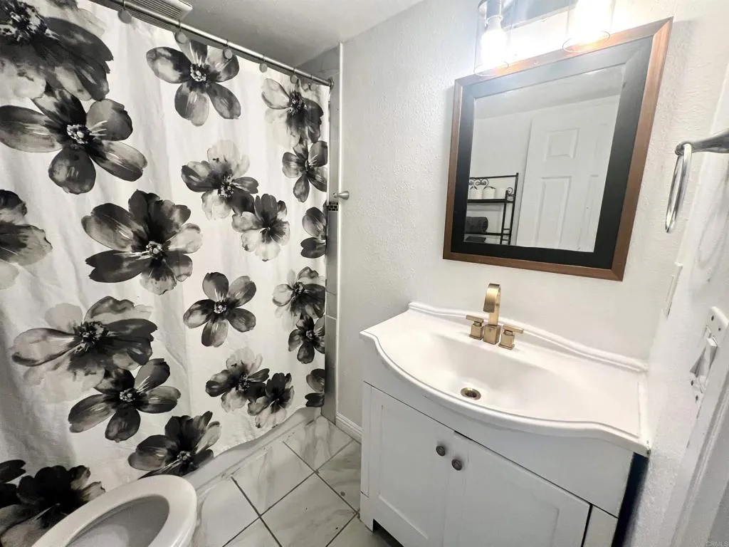 10707 Jamacha Spring Valley, Unit 72 Spring Valley, CA 91978 - Photo 12 of 18 a bathroom with a sink and mirror with bathtub