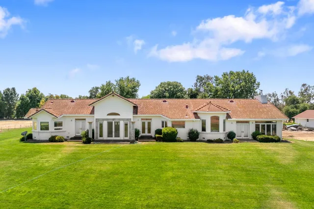 a front view of a house with a garden