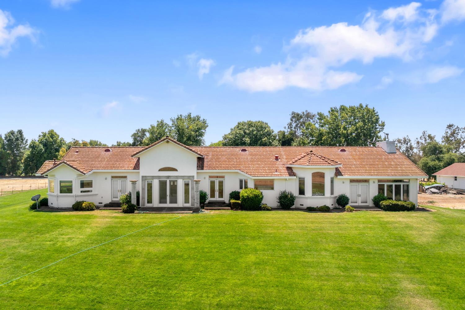 a front view of a house with a garden
