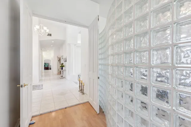 a spacious bedroom with a bed and a chandelier