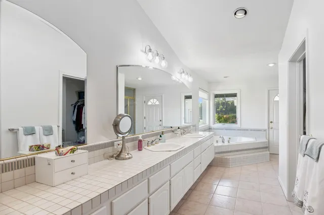 a view of walk in closet with clothes