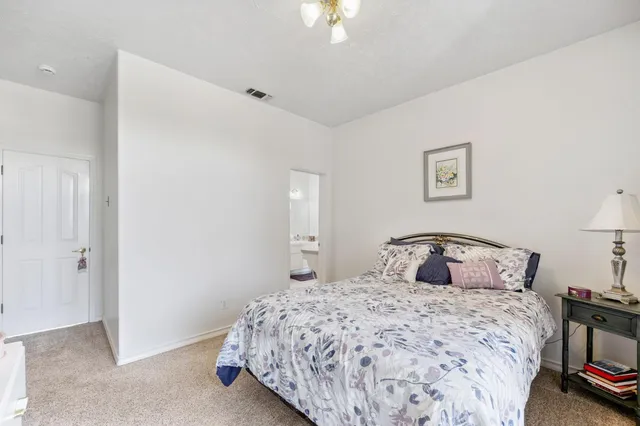 a bathroom with a double vanity sink mirror and toilet