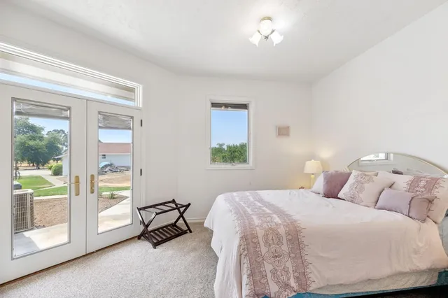 a dining room with furniture and a potted plant