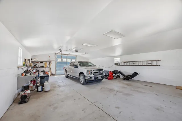 a view of a house with a big yard and large trees