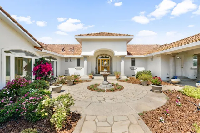 a front view of a house with garden