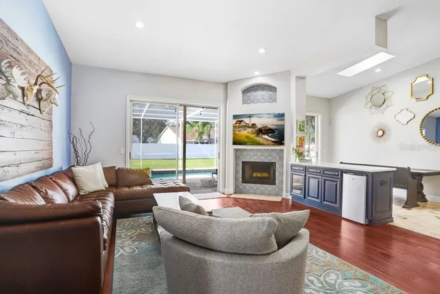 a living room with fireplace furniture and a wooden floor