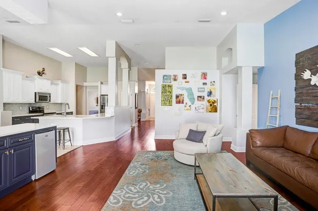 a living room with furniture and a kitchen