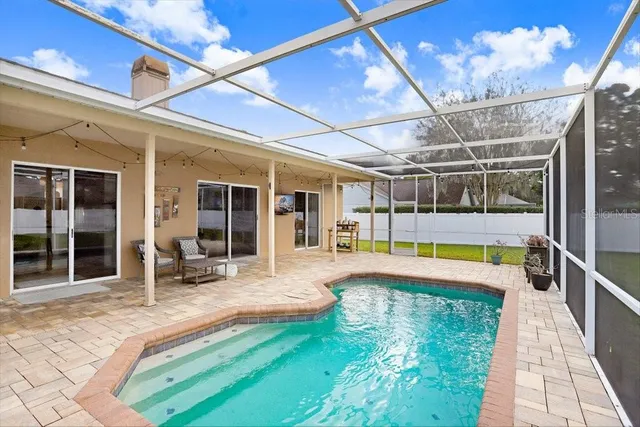 an aerial view of a house with garden space and street view