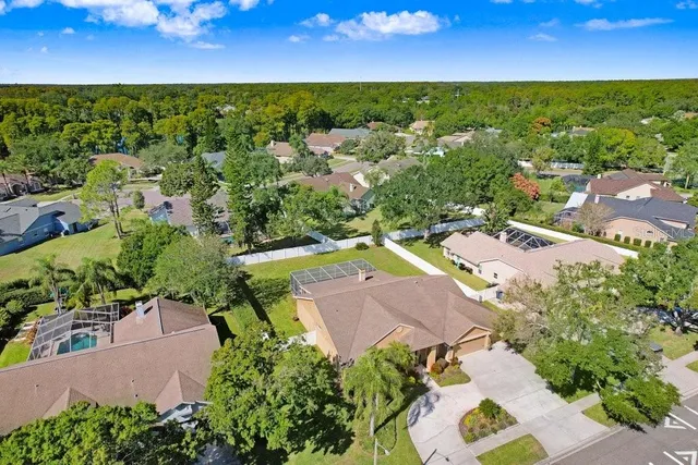 an aerial view of residential houses with outdoor space and street view
