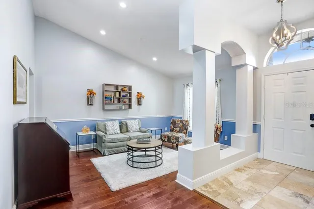 a living room with furniture and wooden floor