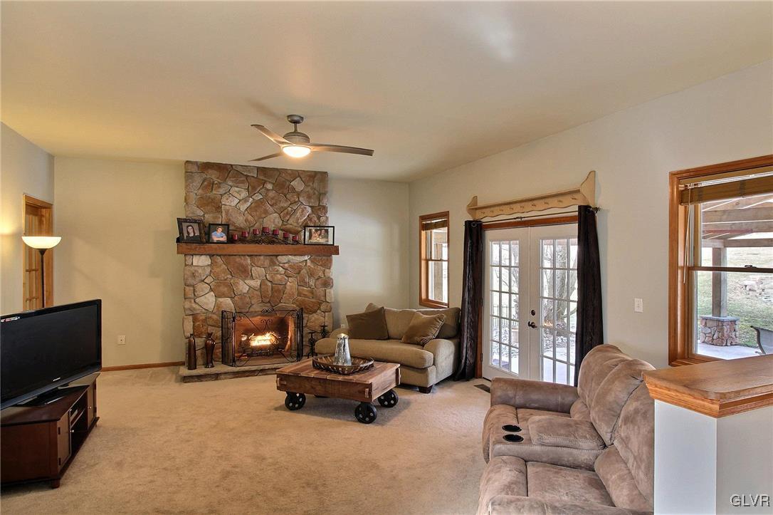 1662 Rachel Road Stroudsburg, PA 18360 - Photo 29 of 44 a living room with furniture a fireplace and a flat screen tv