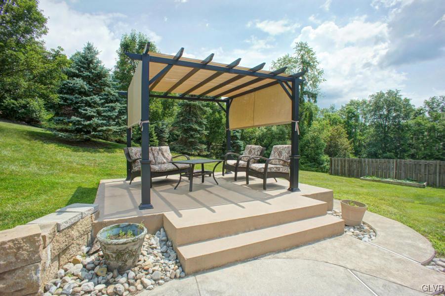 1662 Rachel Road Stroudsburg, PA 18360 - Photo 8 of 44 a view of a patio with couches table and chairs under an umbrella