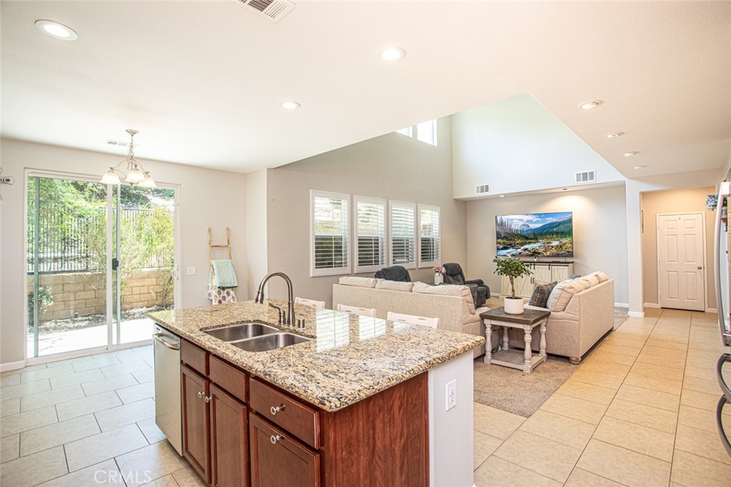 17122 Broken Rock Court Riverside, CA 92503 - Photo 14 of 61 a kitchen with granite countertop a sink and a stove