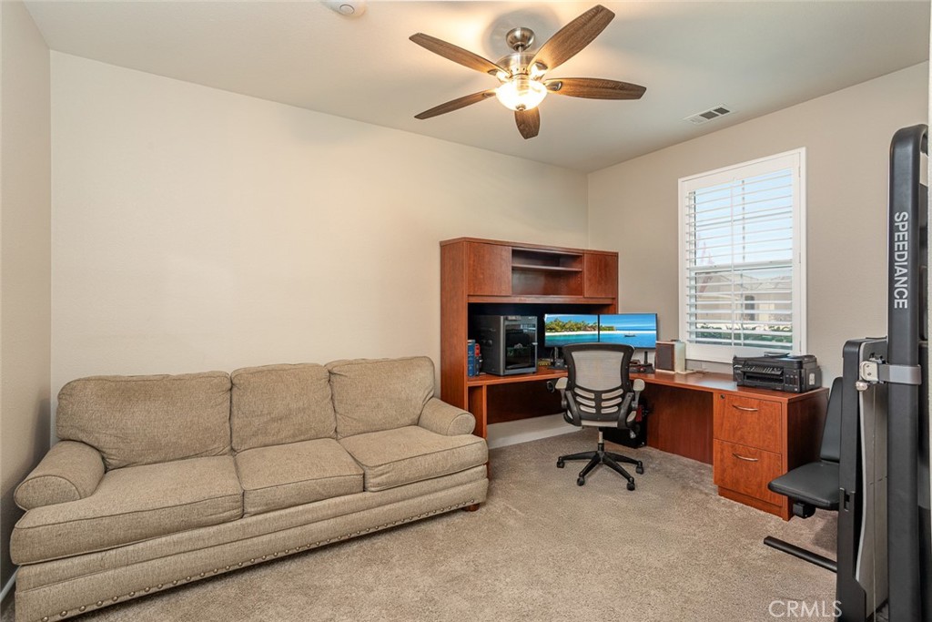 17122 Broken Rock Court Riverside, CA 92503 - Photo 23 of 61 a living room with furniture a ceiling fan and a window