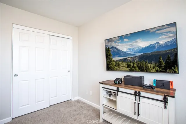 a spacious bedroom with a bed and a window