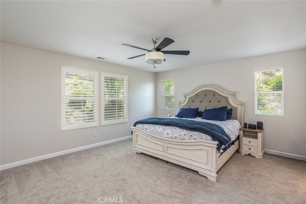 17122 Broken Rock Court Riverside, CA 92503 - Photo 33 of 61 a spacious bedroom with a bed and a window