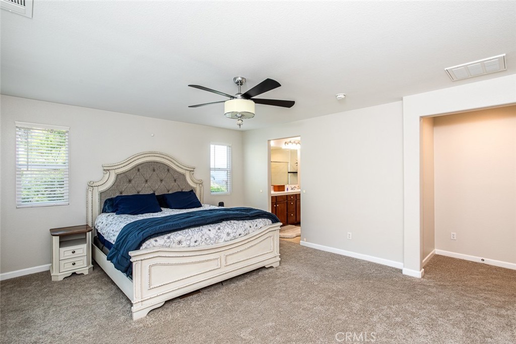 17122 Broken Rock Court Riverside, CA 92503 - Photo 34 of 61 a bedroom with a bed and a ceiling fan