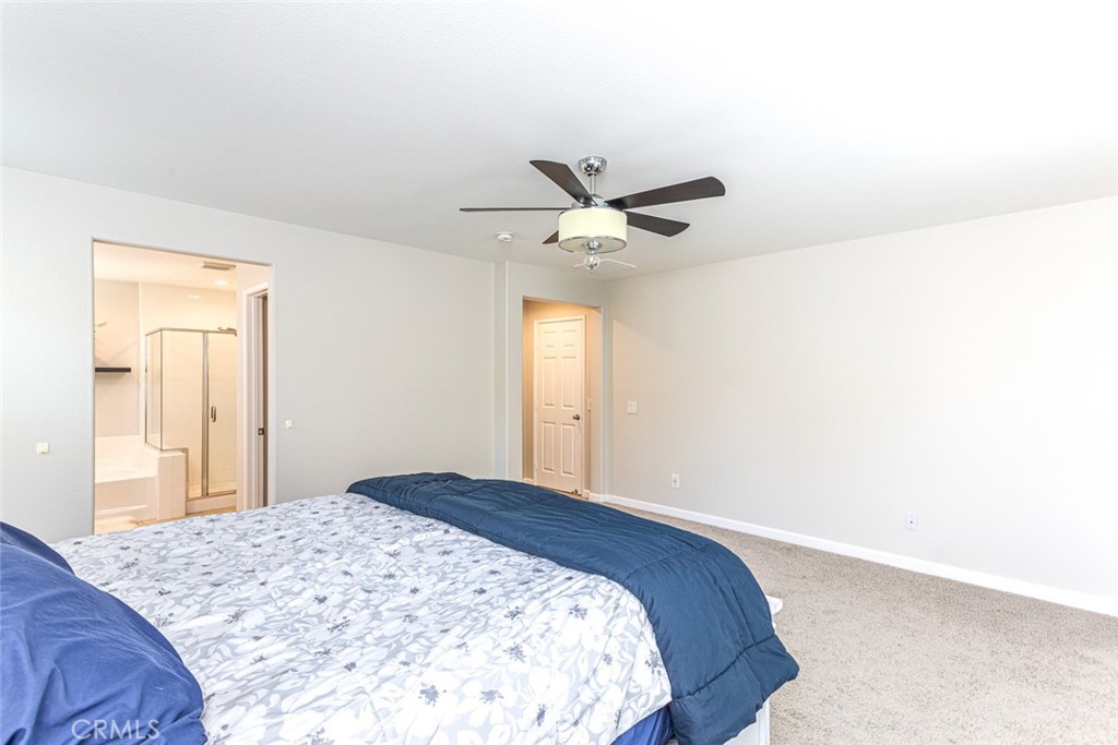 17122 Broken Rock Court Riverside, CA 92503 - Photo 35 of 61 a bedroom with a large bed and a chandelier