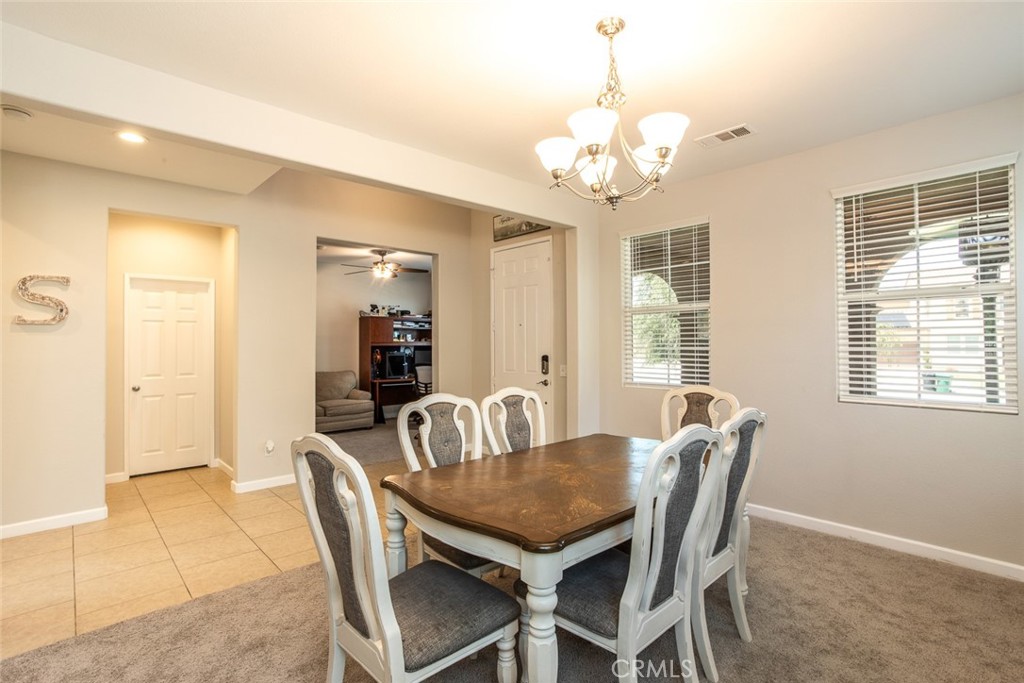 17122 Broken Rock Court Riverside, CA 92503 - Photo 4 of 61 a view of a dining room with furniture and chandelier