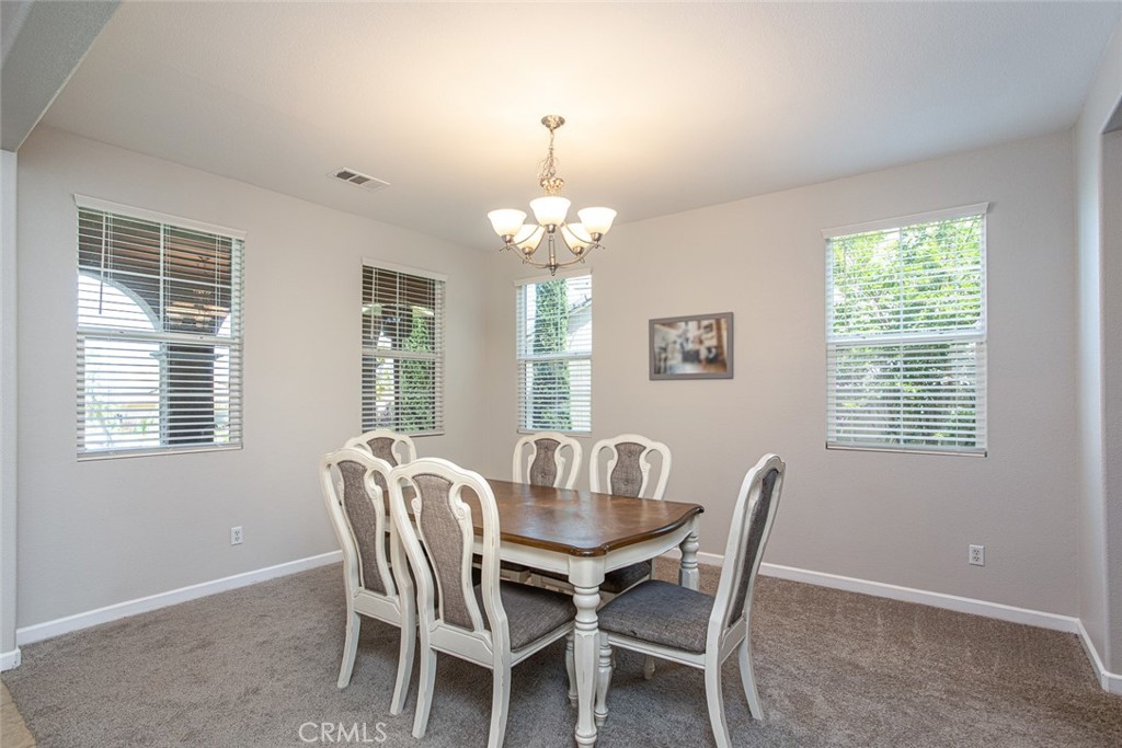 17122 Broken Rock Court Riverside, CA 92503 - Photo 5 of 61 a dining room with furniture a chandelier and window