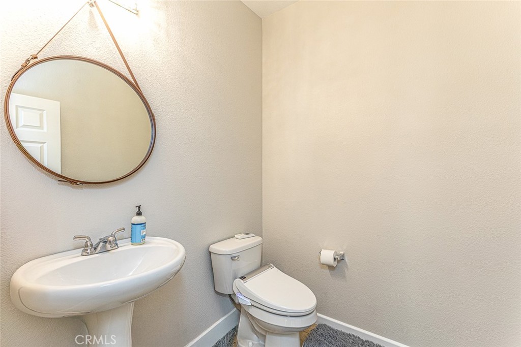 17122 Broken Rock Court Riverside, CA 92503 - Photo 6 of 61 a bathroom with a sink a mirror and a toilet