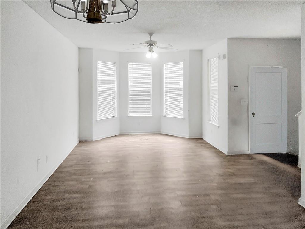 6710 Sunset Hills Boulevard Rex, GA 30273 - Photo 2 of 12 a view of an empty room with chandelier fan and fire place