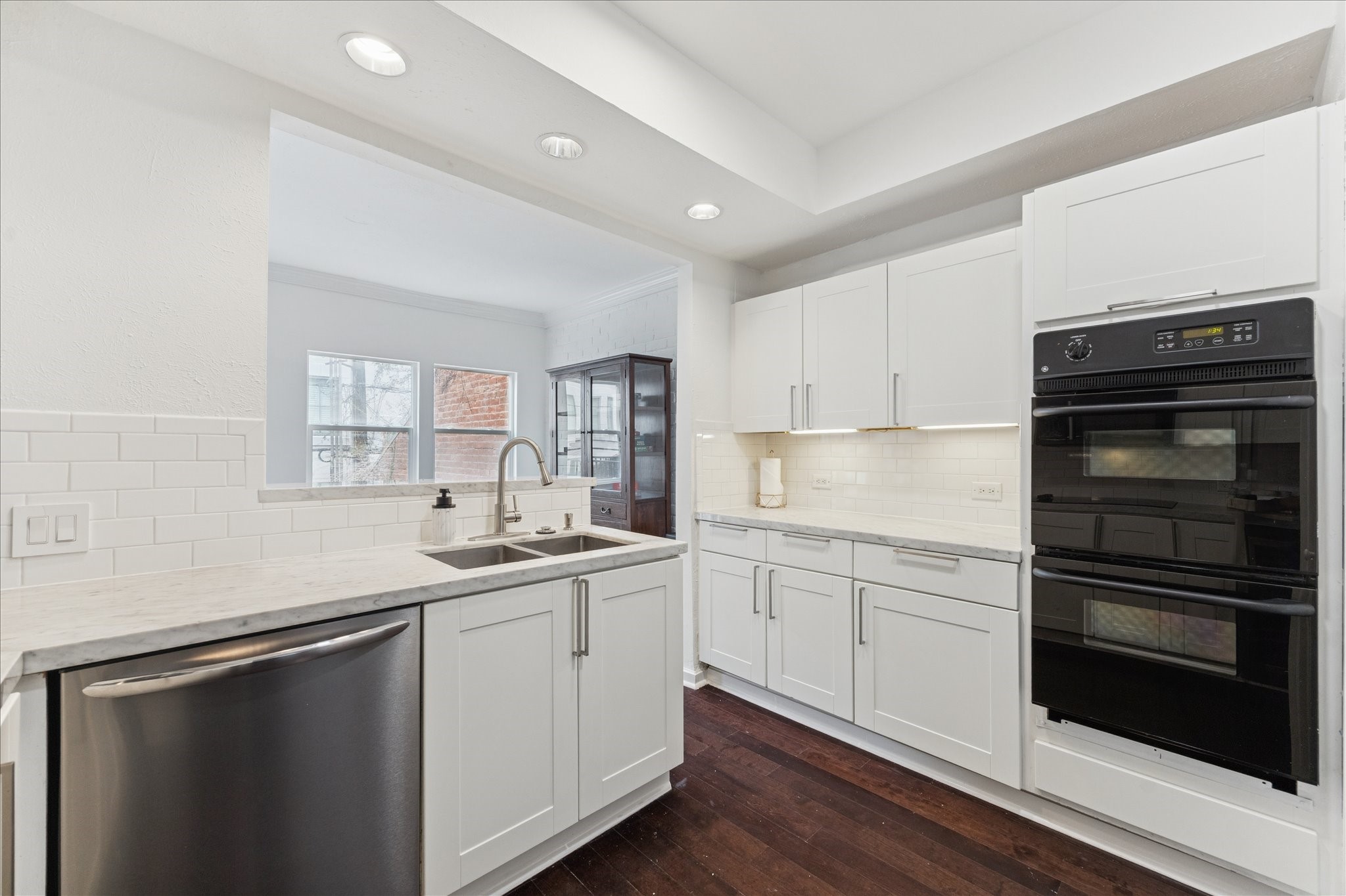2421 Branard Street Houston, TX 77098 - Photo 11 of 28 a kitchen with granite countertop cabinets stainless steel appliances and sink