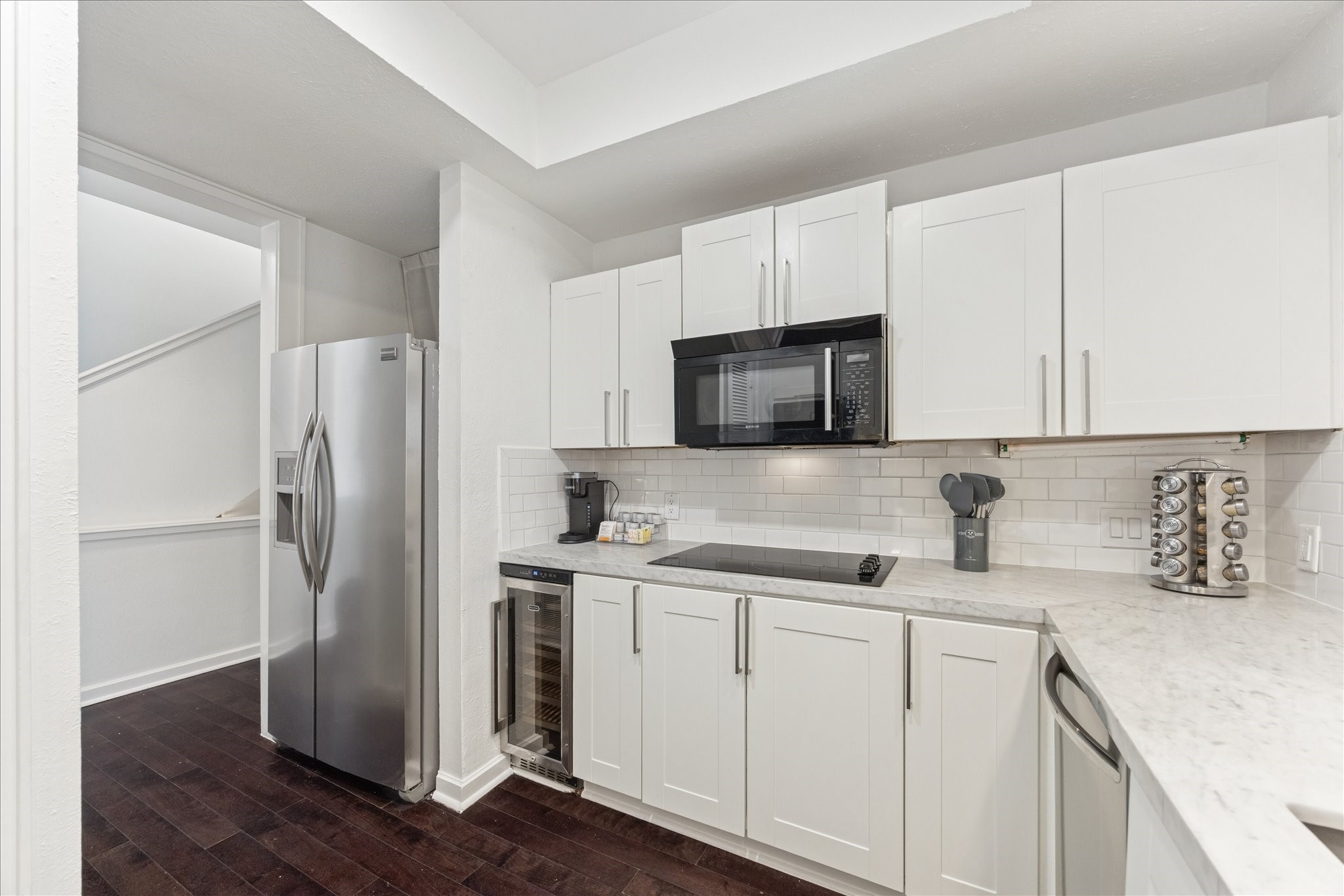 2421 Branard Street Houston, TX 77098 - Photo 12 of 28 a kitchen with a sink a microwave a refrigerator and cabinets