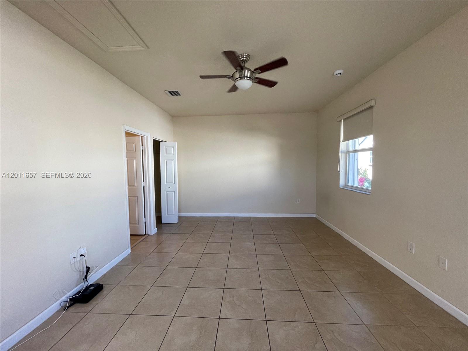 9262 Southwest 171st Court, Unit A Miami, FL 33196 - Photo 2 of 7 a view of an empty room with a window
