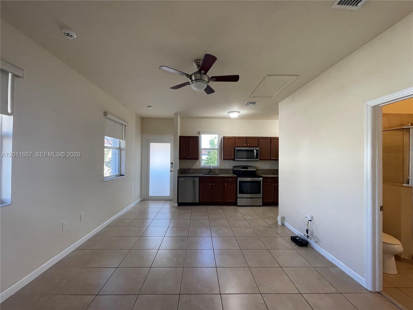 9262 Southwest 171st Court, Unit A Miami, FL 33196 - Photo 3 of 7 a large kitchen with a stove and a refrigerator