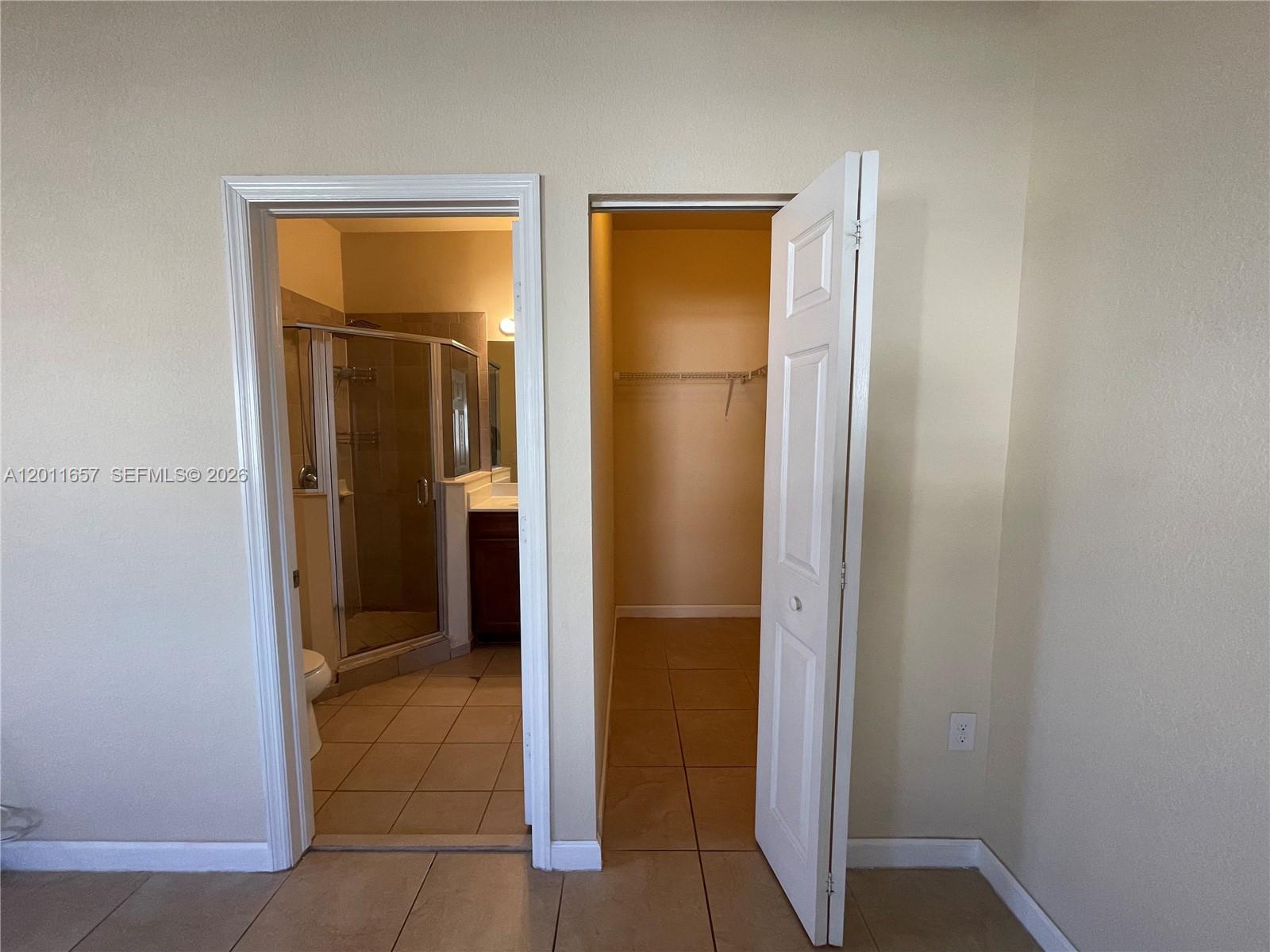 9262 Southwest 171st Court, Unit A Miami, FL 33196 - Photo 5 of 7 an empty room with closet and a bathroom