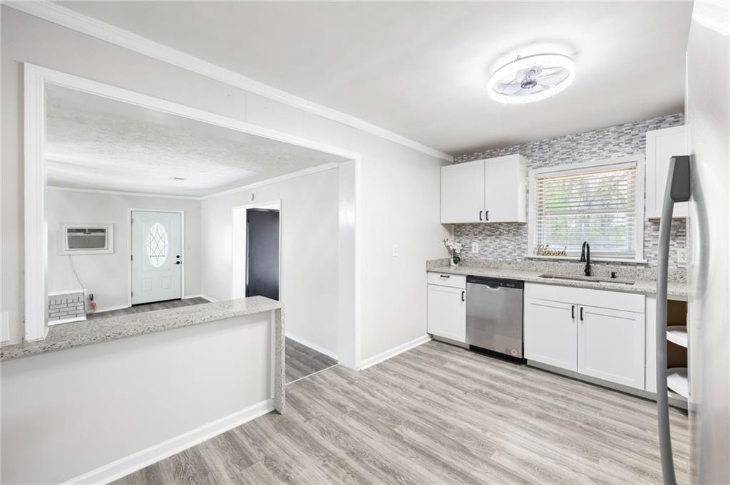 4611 Old Westside Road Austell, GA 30106 - Photo 11 of 37 a kitchen with granite countertop a sink cabinets and stainless steel appliances